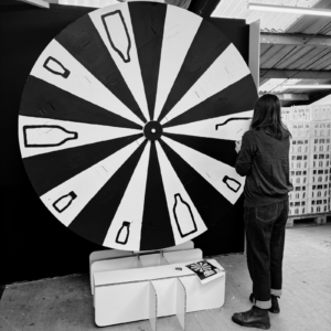 Eleonora Marton painting the FILL REFILL wheel of fortune